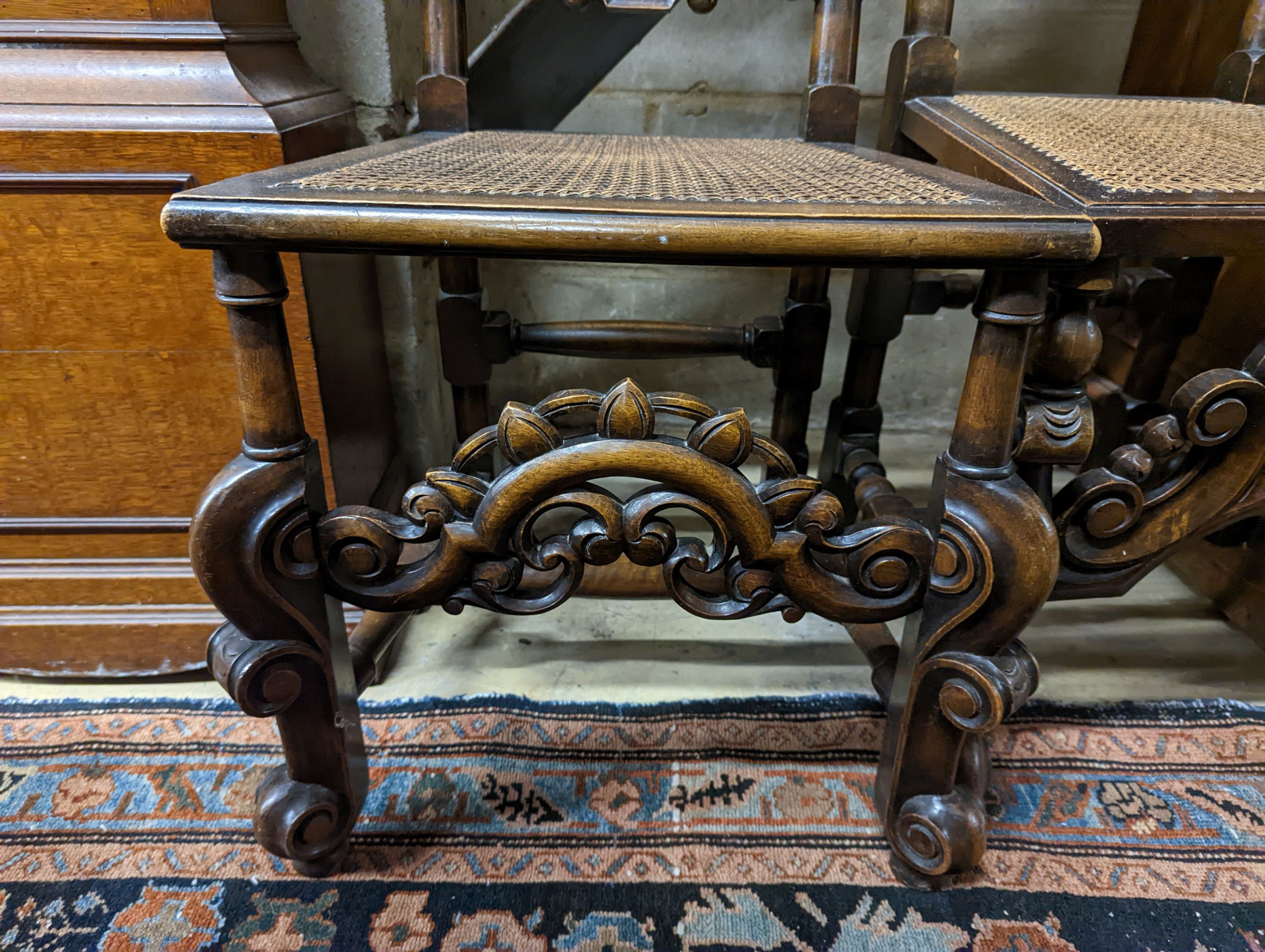 A pair of Carolean design carved beech high back chairs